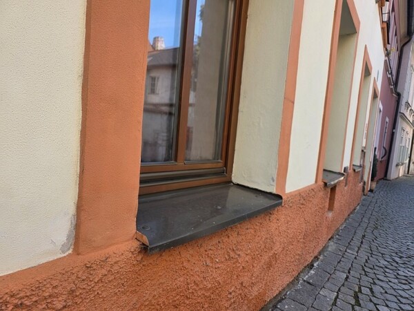 Eurookno a natržený hnědý parapet